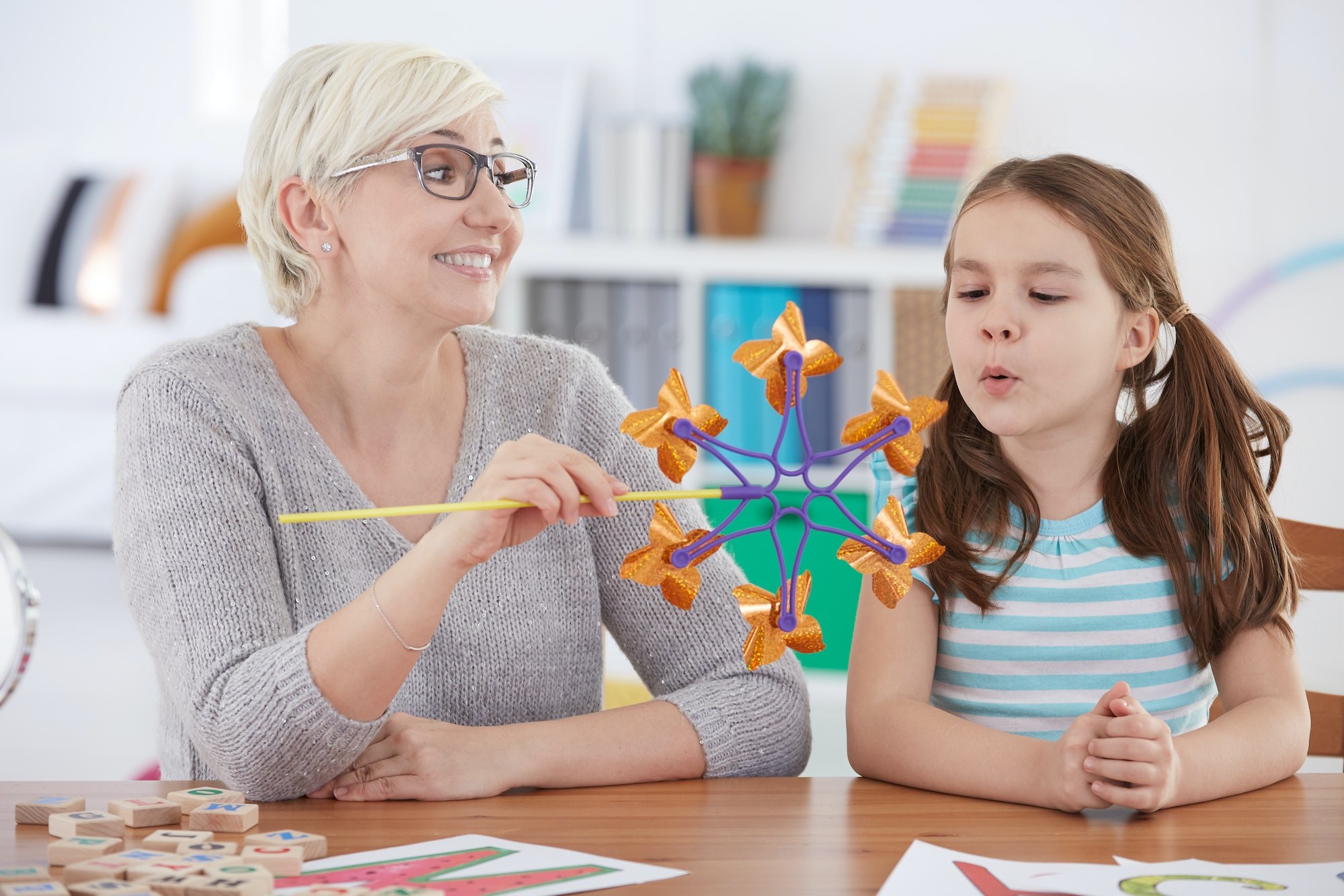 A therapist working through an assessment activity with a child